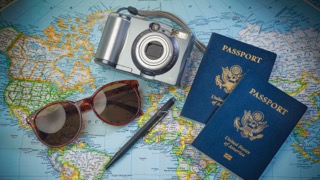 Travel Essentials - Passports, Sunglasses, Camera, Pen